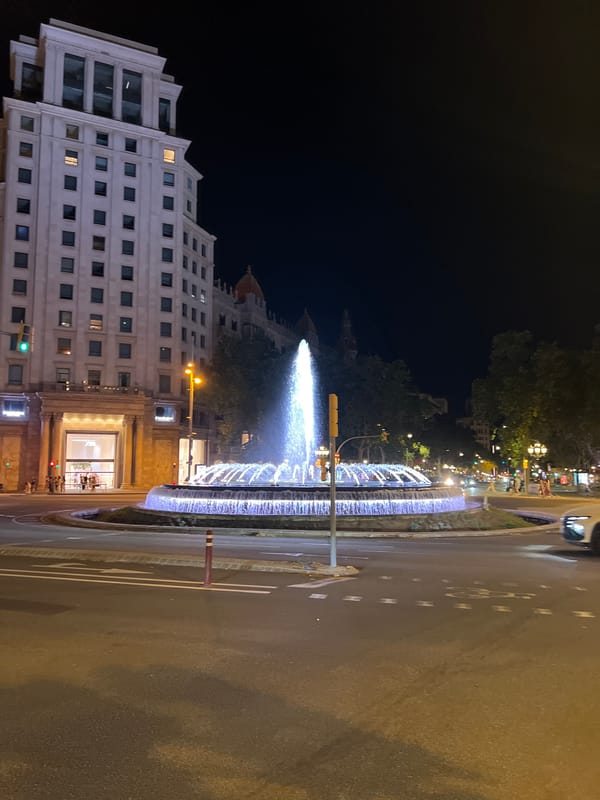 Iconic Barcelona fountain glowing at Passeig de Gràcia by night