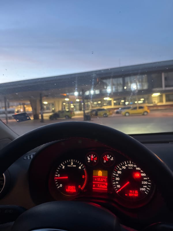 Vehicle dashboard observed while stationary, instruments illuminated