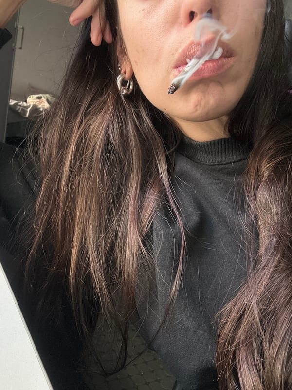 Woman smoking indoors captured in Buenos Aires evening scene
