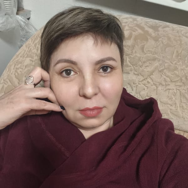 Woman in maroon robe reclining on furniture in Russia