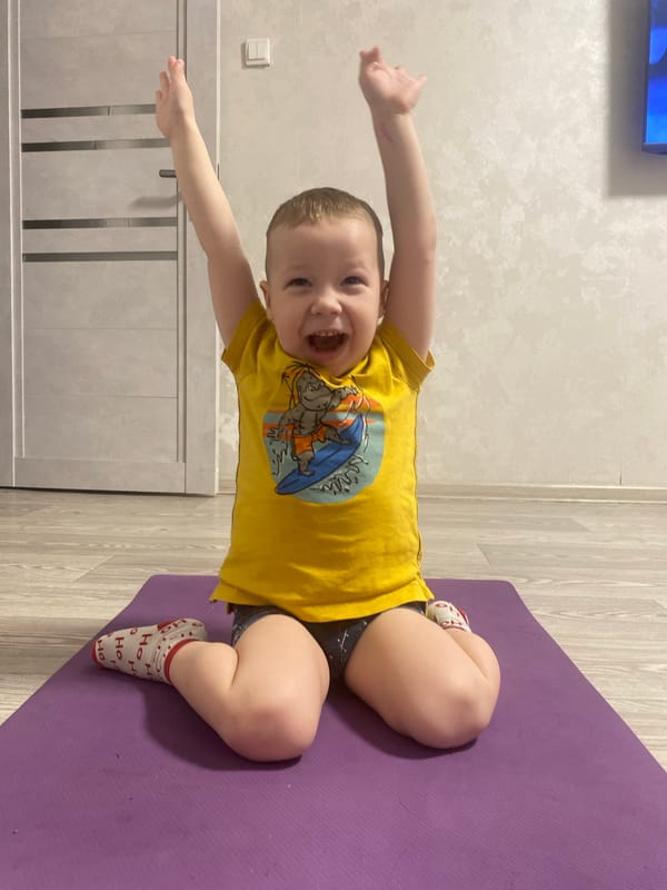 Child practices Sunday yoga routine in Sochi home