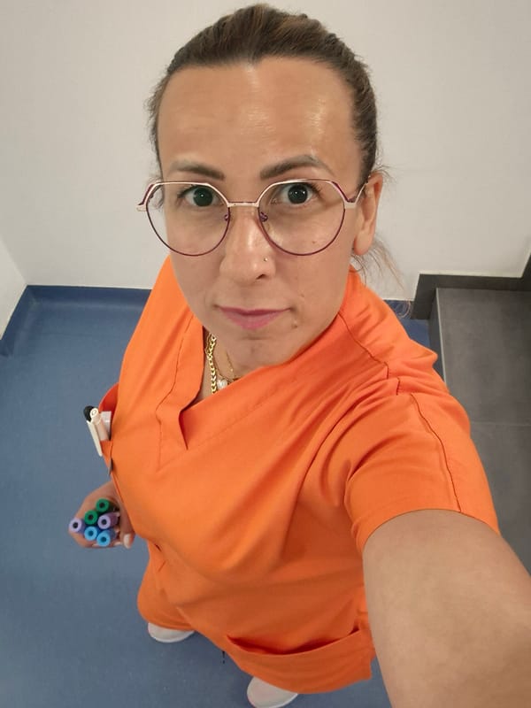 Healthcare worker poses with colorful blood collection tubes