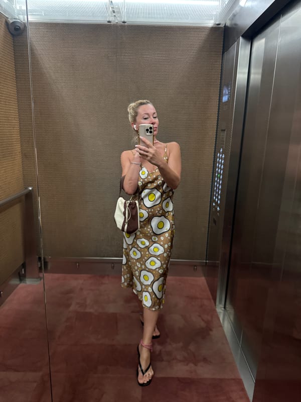 Elevator mirror selfie in a fried egg print dress, Warsaw