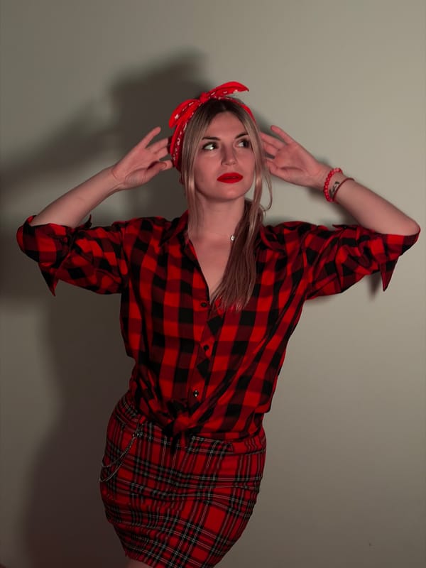 Woman in plaid outfit photographed with Coca-Cola in Budva
