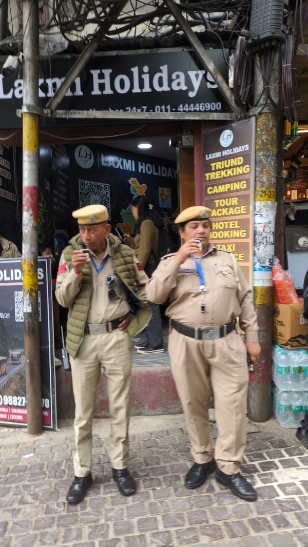Police officers patrol tourist area in Bhagsu, India