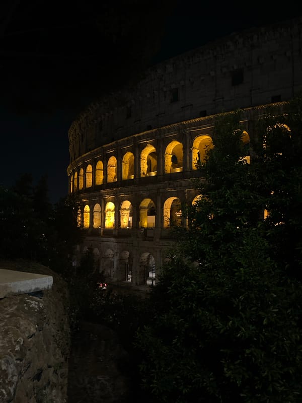 Illuminated Colosseum draws evening visitors in Rome