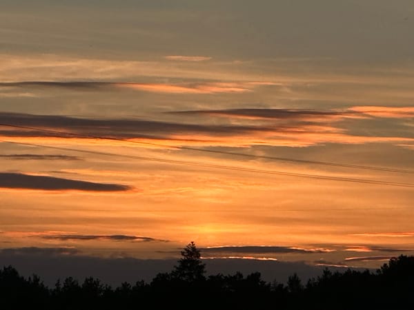 Sunset sky over Yurove, Ukraine, power lines in silhouette