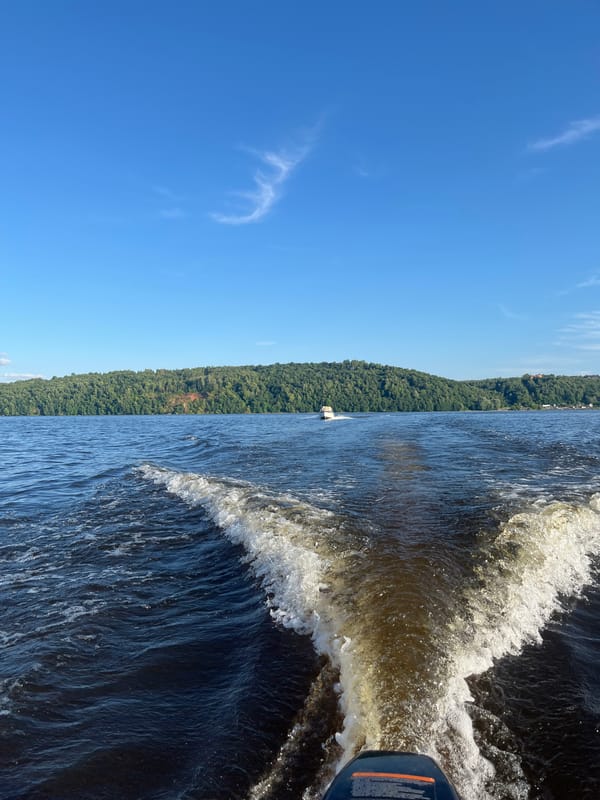 Afternoon on the water near forested shores in rural Russia