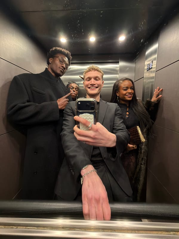 Four people take mirror selfie in London elevator