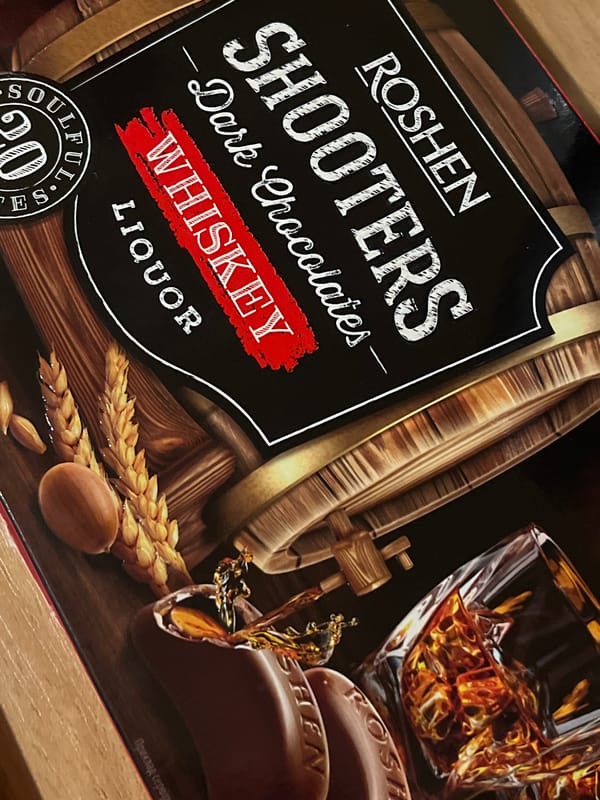 Roshen snacks, kitchen gear, and drinks on a Lviv table