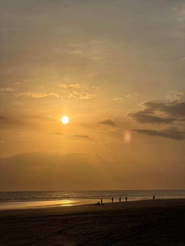 Golden sunset observed through clouds at Indonesian beach
