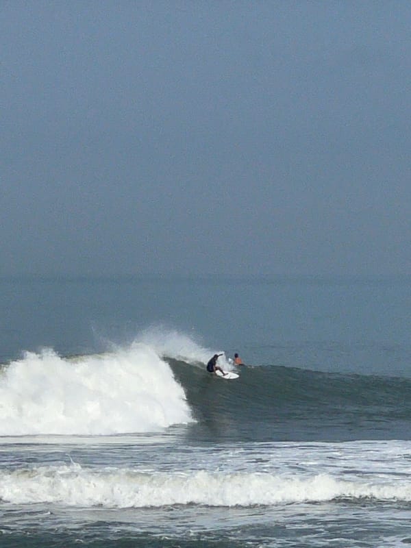 Morning at Echo Beach: surfers, temples, and coastline activity
