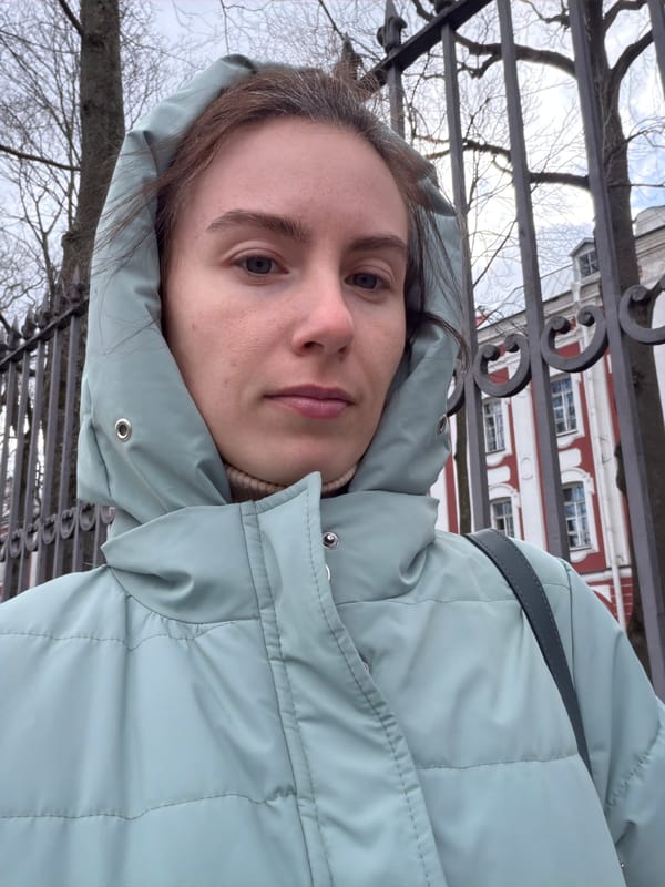 Woman in blue jacket spotted near fence in Saint Petersburg