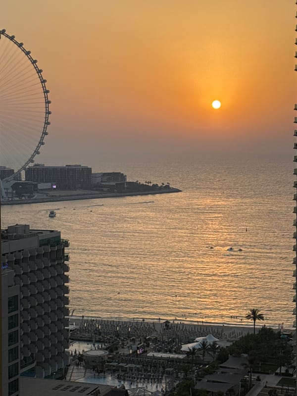 Dubai waterfront glows at sunset, Ain Dubai in view