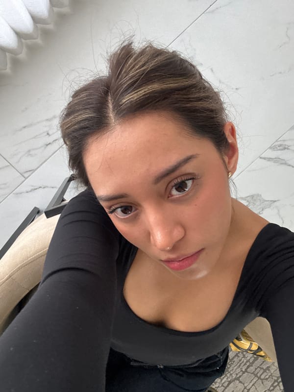 Woman takes selfies at Hotel Cartesiano lobby in Puebla