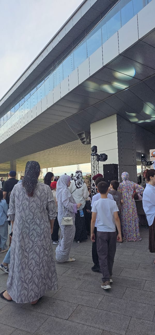 Busy afternoon around Grozny City's shops, fountain, and riverside
