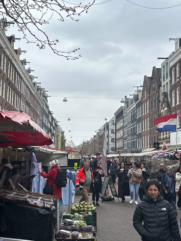 Amsterdam street market and escalator scenes captured simultaneously
