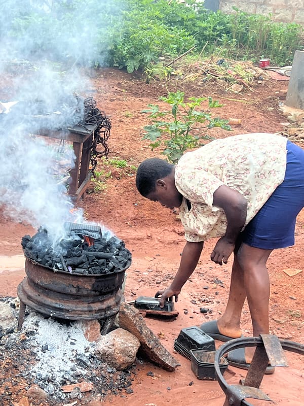 Charcoal fire tended at outdoor brazier in Nkpor, Nigeria