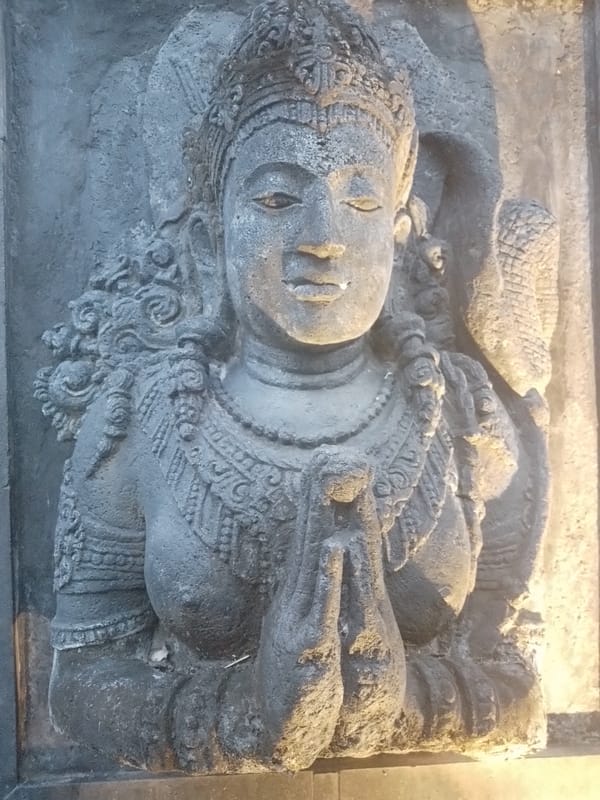 Ornate relief sculpture of reclining figure observed in North Kuta