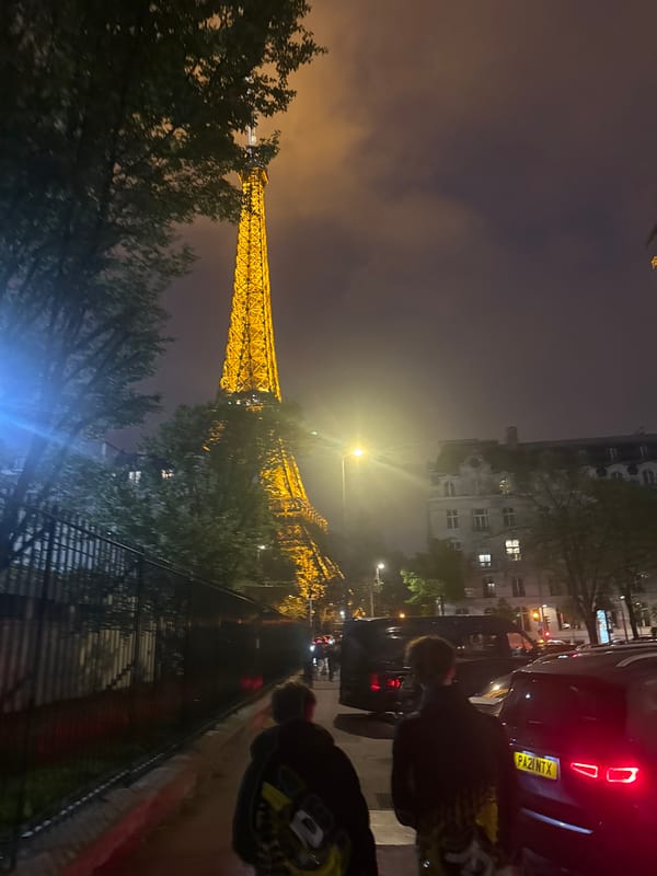 Eiffel Tower glows yellow in evening Paris scene