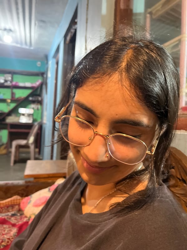 Two people, casual indoor hangout, phones and portraits