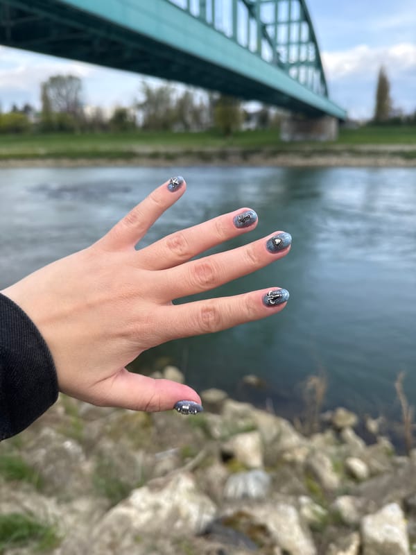 Person with colorful hair takes selfies by Zagreb bridge