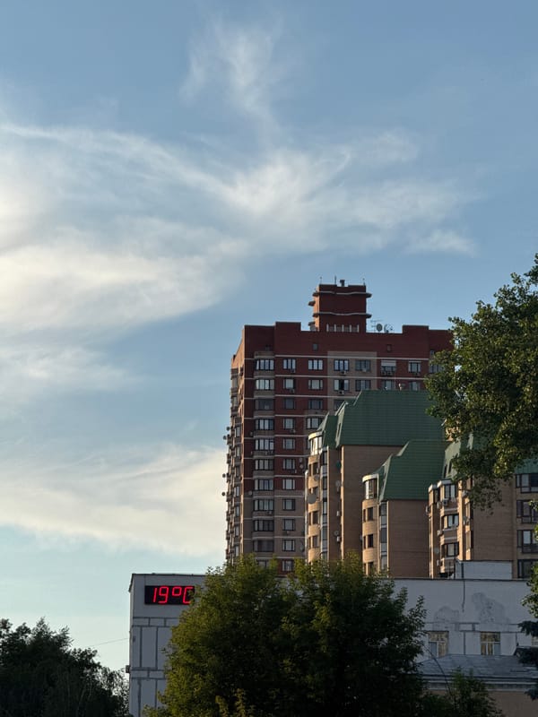 Cool evening pause near city high-rises, 19°C