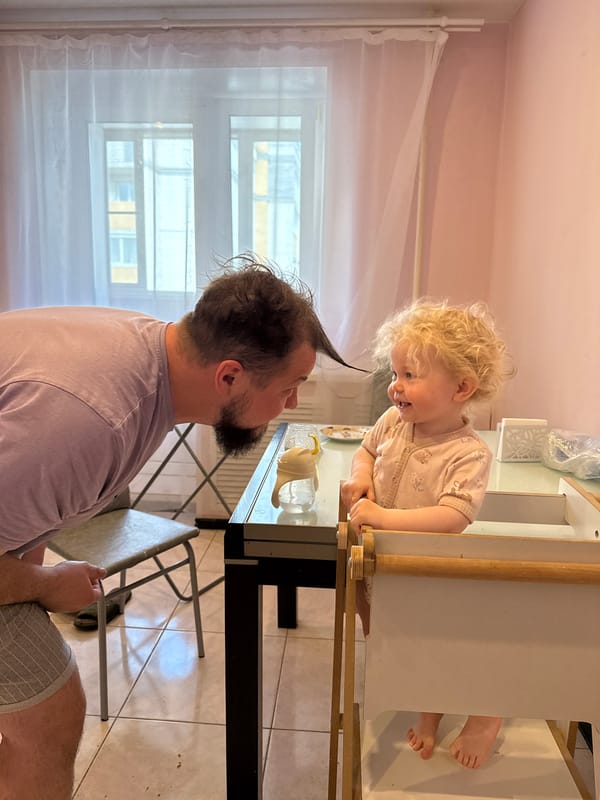 Adult and toddler interact at playground in Vladimir