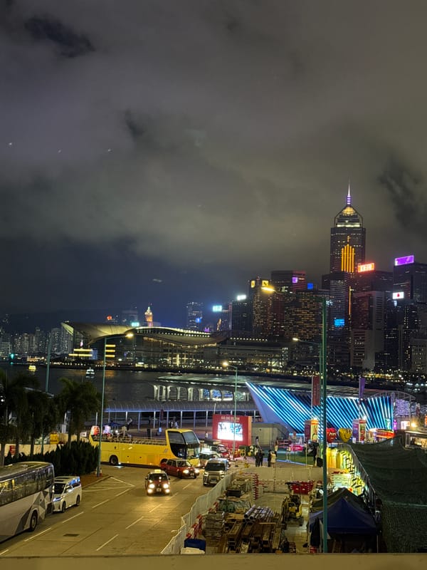 Hong Kong skyline captured at night with illuminated observation wheel