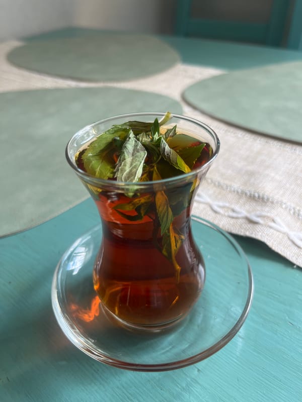 Dark mint tea on a teal surface in Voronezh
