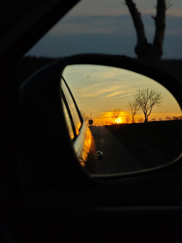 Sunset reflected in car mirror on Bulgarian road