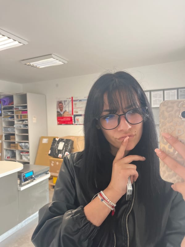 Woman in leather jacket takes selfies with cigarettes indoors