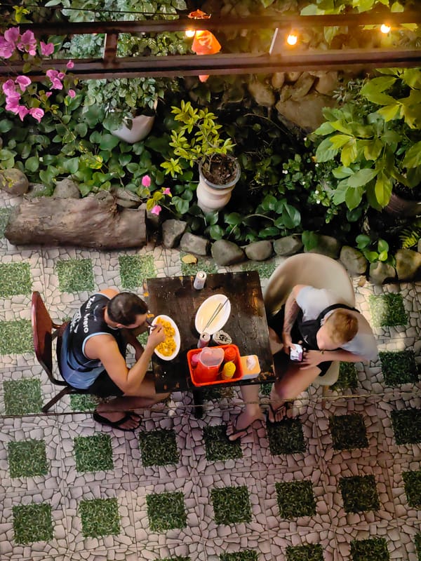 Two people dining outdoors in Bai Chay Ward, Vietnam