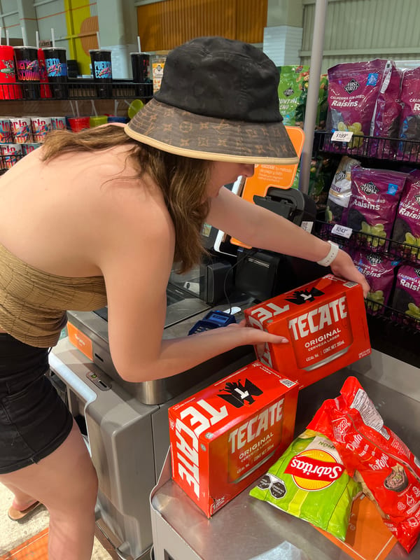 Woman purchases beer at Puerto Escondido grocery store