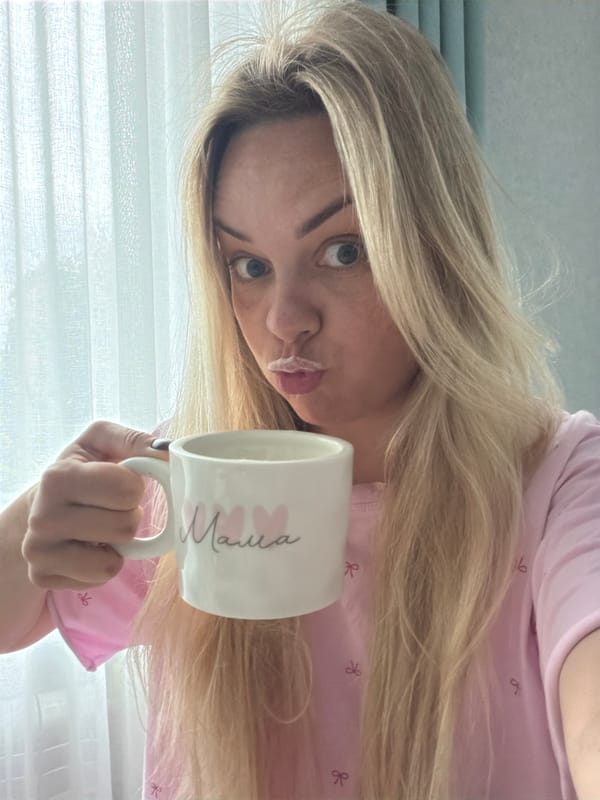 Woman drinks from 'Mama' mug in Votkinsk morning scene
