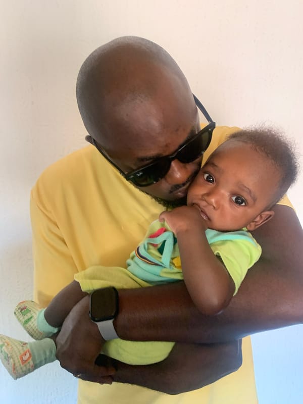 Man holds baby in intimate moment, Barakin Akawo, Nigeria
