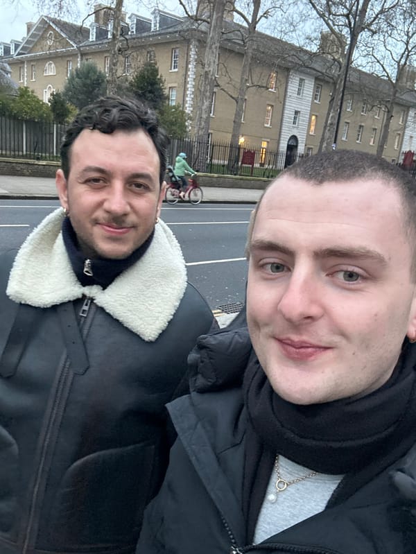Two men take selfie in overcast London afternoon