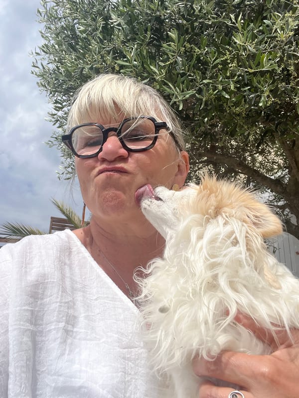 Woman and small dog share tender moments in Montarnaud