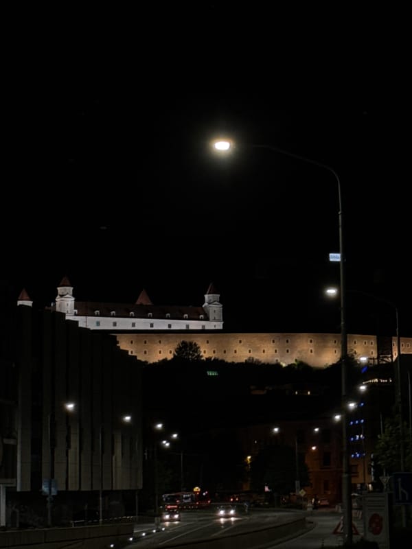 Nighttime view captured of illuminated Bratislava Castle and historic walls