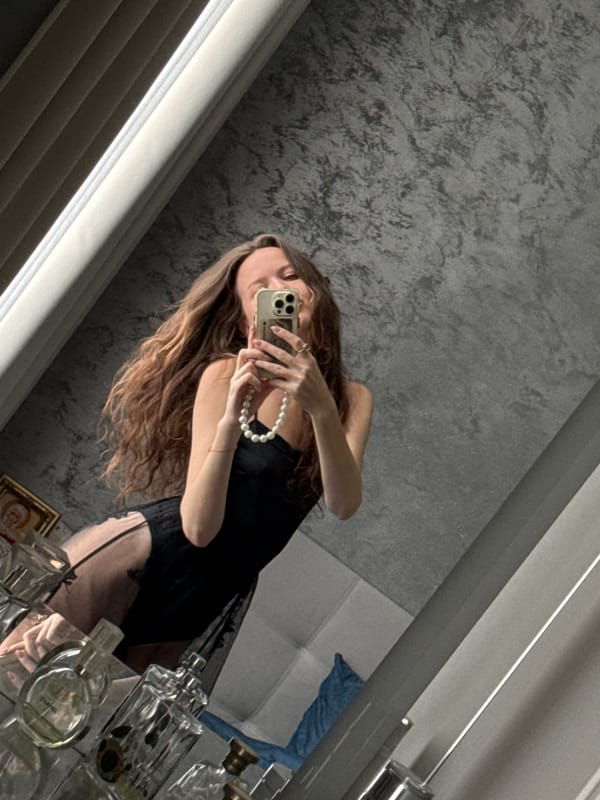 Woman takes bathroom selfies in black robe, towel