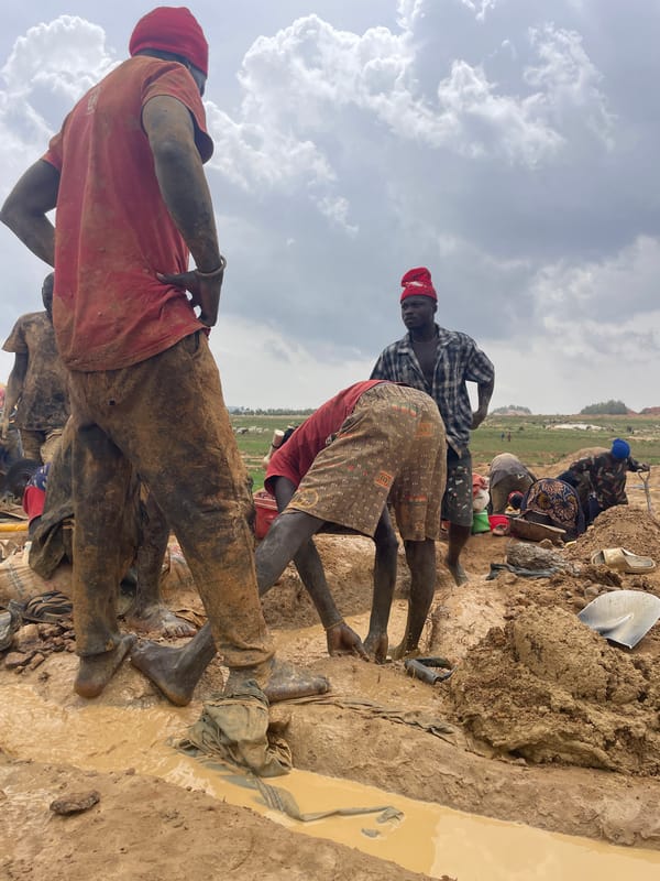 Workers conduct muddy mining operations in Maiyanga, Nigeria