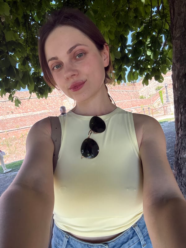 Woman takes selfie near brick structure in Belgrade