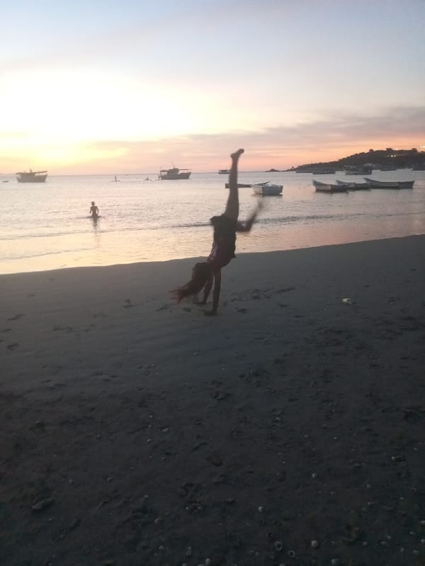 Sunset beach gathering features gymnastics, hand-holding at Juan Griego