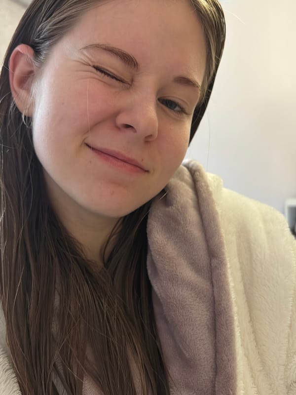 Young person documents skincare routine in selfie session