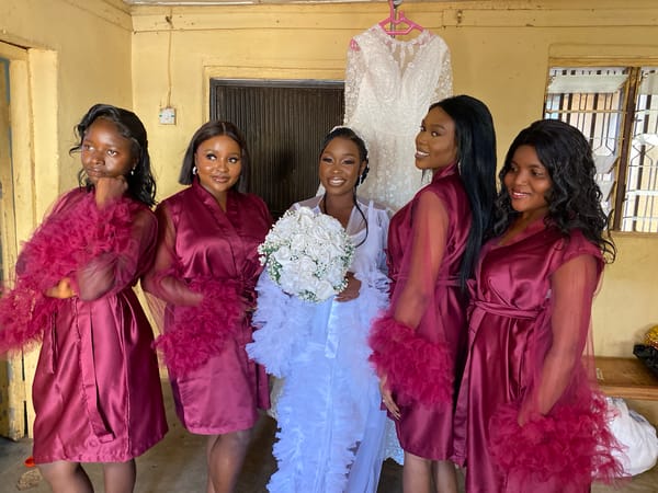 Nigerian bride poses with wedding party during ceremony preparations