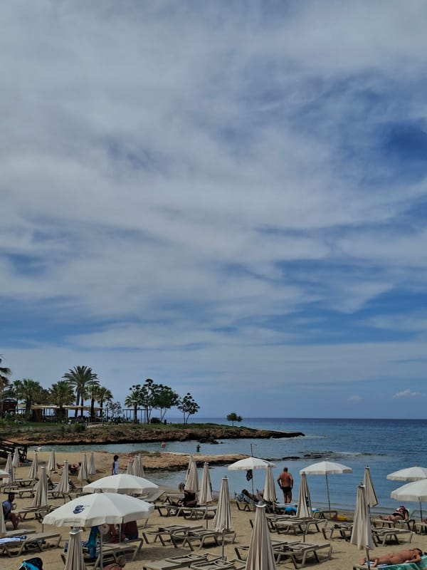 Beach scene with diagonal horizon captured under cloudy skies