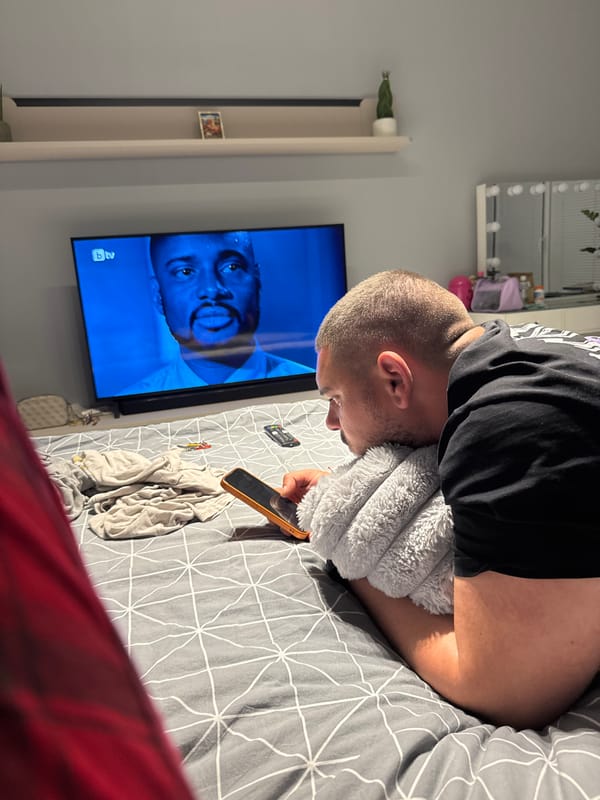 Man uses phone while resting in bed in Sofia