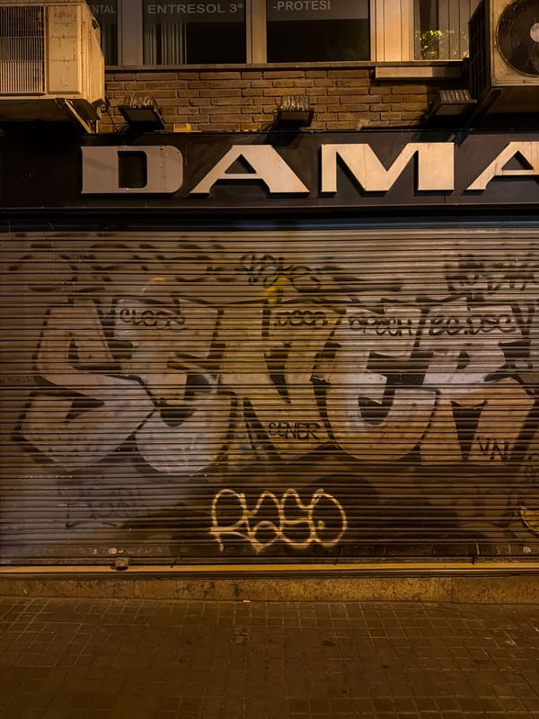 Barcelona's old city at night, monuments lit and most shops shut