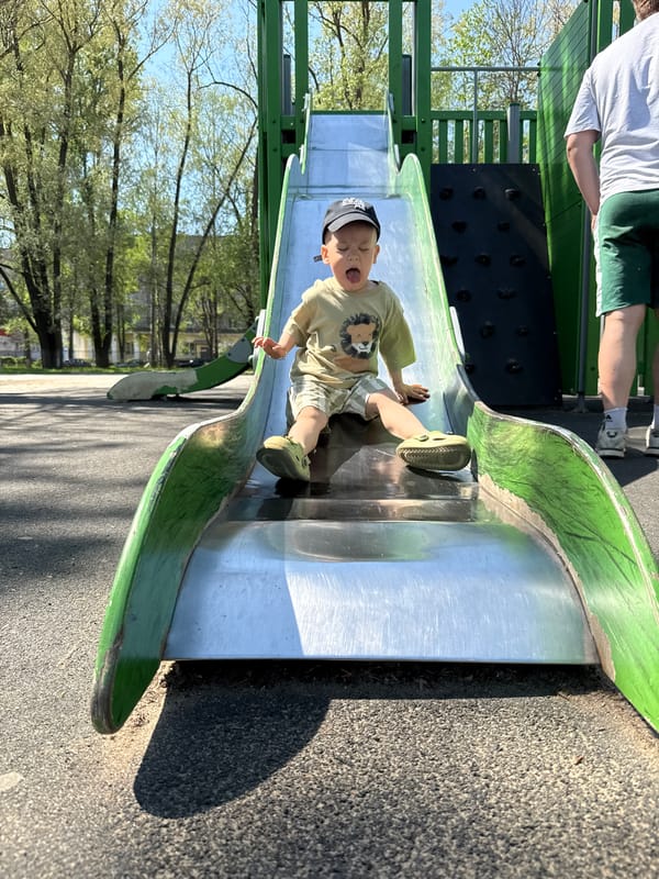 Child plays on playground slide in Rusanovo, Russia