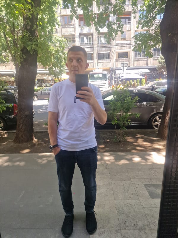 Morning street life in Yerevan, with cars, cafés, and strays